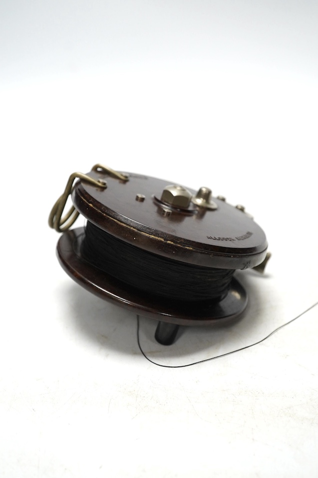 Four fishing reels, including a Bakelite Alcock Aerialite, an Elo, a Seprage C.A.P and a wooden reel, largest 10.5cm diameter. Condition - used, fair